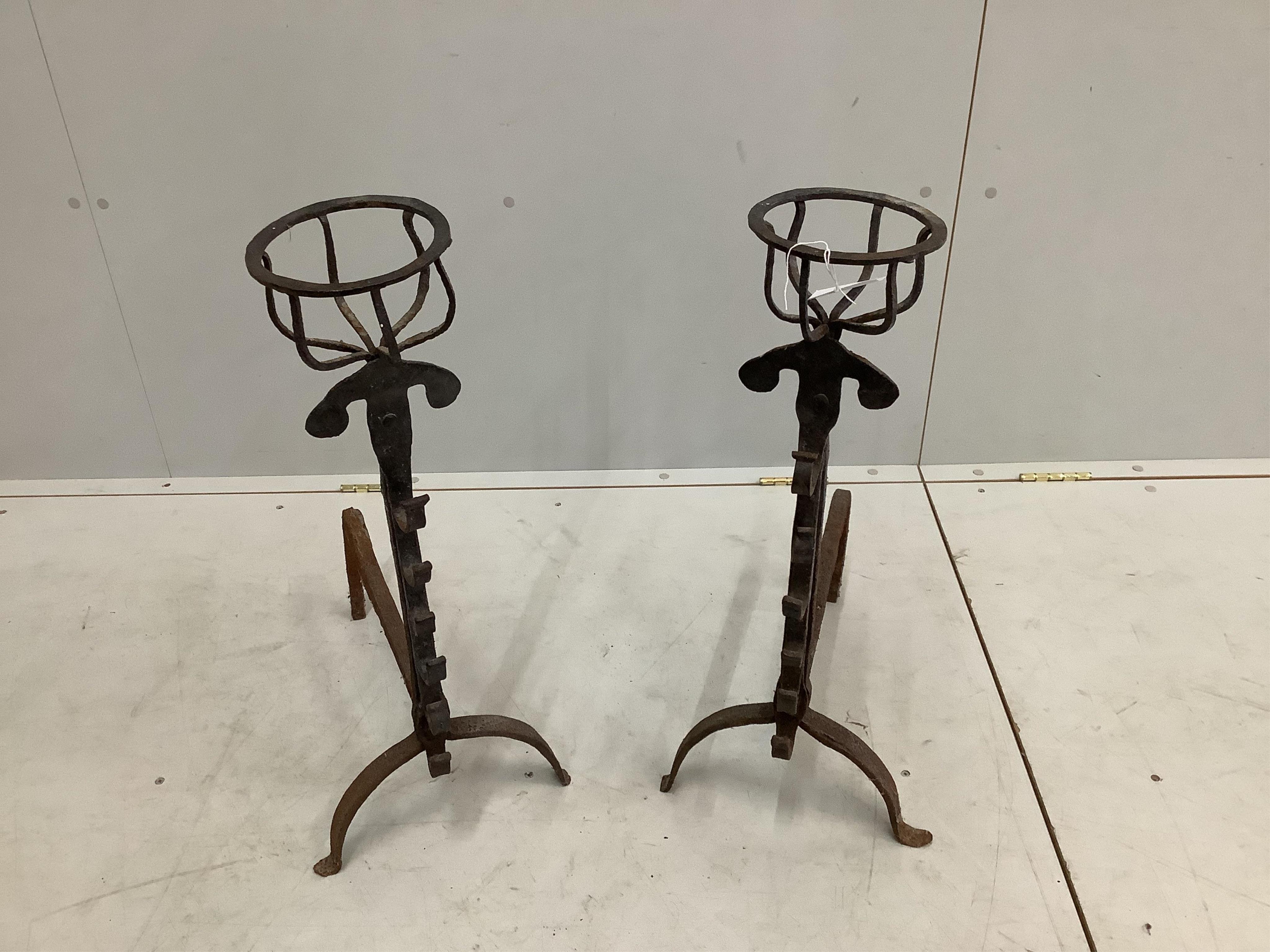 A pair of wrought iron fire dogs, height 70cm. Condition - fair